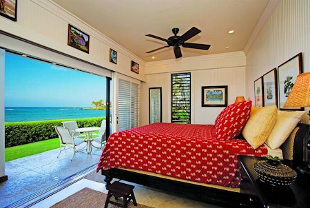King bed in oceanfront unit at the Castle Kiahuna Plantation Beach Bungalows