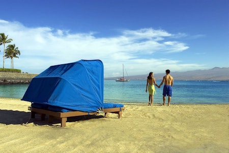 A blue beach cabana for 2, next to the water