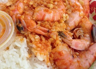 A tight shot of a plate of shrimp and rice