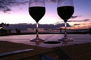 Wine Glasses Hawaii Sunset Two glasses of red wine with Hawaiian sunset in background